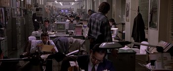 Movie still from “Black Rain” (1989), directed by Ridley Scott – A group of people working in an office space; Wide shot, High angle
