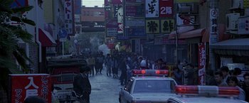 Movie still from “Black Rain” (1989), directed by Ridley Scott – A crowd of people walking down a street; Extreme Wide shot, High angle