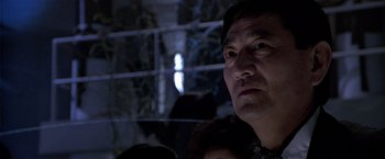 Movie still from “Black Rain” (1989), directed by Ridley Scott – A person looking at the camera; Close Up shot, Low angle