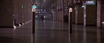 Movie still from “Black Rain” (1989), directed by Ridley Scott – People are walking in an empty train station at night; Extreme Wide shot, High angle