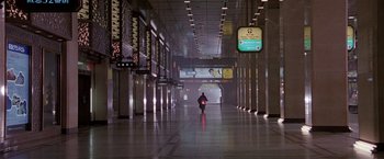 Movie still from “Black Rain” (1989), directed by Ridley Scott – A person is walking in an empty train station; Extreme Wide shot, Low angle
