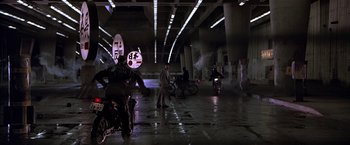 Movie still from “Black Rain” (1989), directed by Ridley Scott – A group of people riding motorcycles in a tunnel; Wide shot, Low angle