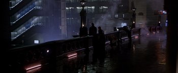 Movie still from “Black Rain” (1989), directed by Ridley Scott – Two people are standing on a bridge at night; Extreme Wide shot, High angle