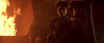 Movie still from “Black Rain” (1989), directed by Ridley Scott – A man standing in front of a wall with his eyes closed; Close Up shot, Low angle