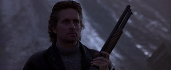 Movie still from “Black Rain” (1989), directed by Ridley Scott – A person holding a gun; Close Up shot, Low angle