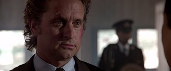 Movie still from “Black Rain” (1989), directed by Ridley Scott – A person wearing a suit and tie; Close Up shot, Over the shoulder angle