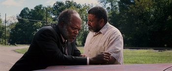 Movie still from “Black Snake Moan” (2006), directed by Craig Brewer – Two men in business suits sitting at a picnic table; Medium shot, Over the shoulder angle