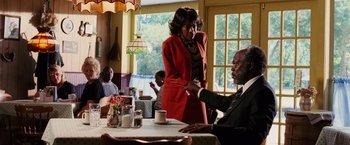 Movie still from “Black Snake Moan” (2006), directed by Craig Brewer – A man and a woman are standing at a table in a restaurant; Medium shot, Over the shoulder angle