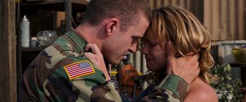 Movie still from “Black Snake Moan” (2006), directed by Craig Brewer – A man and a woman in military fatigues holding each other; Close Up shot, Over the shoulder angle