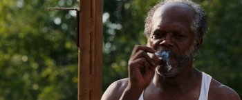 Movie still from “Black Snake Moan” (2006), directed by Craig Brewer – An older man is smoking a cigarette outside; Close Up shot, Low angle