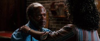 Movie still from “Black Snake Moan” (2006), directed by Craig Brewer – An older man is being examined by an older woman; Close Up shot, Over the shoulder angle