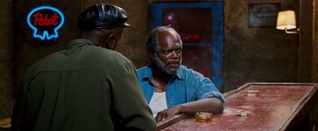 Movie still from “Black Snake Moan” (2006), directed by Craig Brewer – Two men sitting at a table talking to each other; Medium shot, Over the shoulder angle