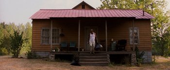 Movie still from “Black Snake Moan” (2006), directed by Craig Brewer – A man walking up the steps of a house; Wide shot, Low angle