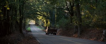 Movie still from “Black Snake Moan” (2006), directed by Craig Brewer – An old pick - up truck driving down the road; Extreme Wide shot, Over the shoulder angle