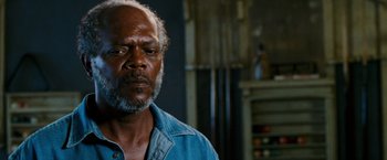 Movie still from “Black Snake Moan” (2006), directed by Craig Brewer – An older man in a blue shirt is looking at the camera; Close Up shot, Over the shoulder angle