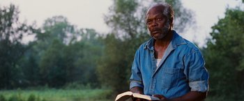Movie still from “Black Snake Moan” (2006), directed by Craig Brewer – An older man is holding a book in his hands; Close Up shot, Low angle