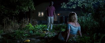 Movie still from “Black Snake Moan” (2006), directed by Craig Brewer – A man and a woman in a yard at night; Wide shot, Over the shoulder angle