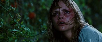 Movie still from “Black Snake Moan” (2006), directed by Craig Brewer – A woman with a bruised face in the woods; Close Up shot, Low angle
