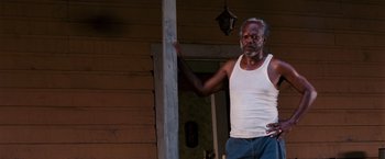 Movie still from “Black Snake Moan” (2006), directed by Craig Brewer – An older man standing next to a wooden pole; Medium shot, Low angle