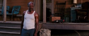 Movie still from “Black Snake Moan” (2006), directed by Craig Brewer – An older man standing in front of an old house; Medium shot, Low angle