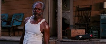 Movie still from “Black Snake Moan” (2006), directed by Craig Brewer – An older man standing in front of a building; Close Up shot, Over the shoulder angle
