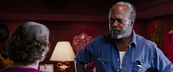 Movie still from “Black Snake Moan” (2006), directed by Craig Brewer – An older man standing in front of a lamp in a room; Close Up shot, Over the shoulder angle