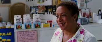 Movie still from “Black Snake Moan” (2006), directed by Craig Brewer – A woman standing in front of a wall with various items on the wall; Close Up shot, Over the shoulder angle