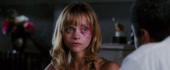 Movie still from “Black Snake Moan” (2006), directed by Craig Brewer – A woman with a bruised face and a messy hair style; Close Up shot, Over the shoulder angle