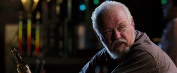 Movie still from “Black Snake Moan” (2006), directed by Craig Brewer – An older man with white hair and a goatee stares into the camera; Close Up shot, Over the shoulder angle