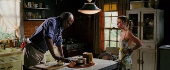 Movie still from “Black Snake Moan” (2006), directed by Craig Brewer – A man and a woman in a kitchen preparing food; Medium shot, Low angle