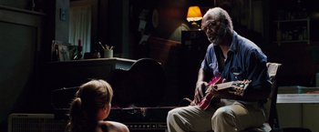 Movie still from “Black Snake Moan” (2006), directed by Craig Brewer – An older man and a young girl are playing a guitar; Medium shot, Over the shoulder angle