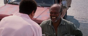 Movie still from “Black Snake Moan” (2006), directed by Craig Brewer – Two men talking to each other in front of a truck; Close Up shot, Over the shoulder angle