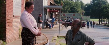 Movie still from “Black Snake Moan” (2006), directed by Craig Brewer – A man and a woman standing on the side of the street; Medium shot, Over the shoulder angle