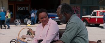 Movie still from “Black Snake Moan” (2006), directed by Craig Brewer – An older man and a younger woman sitting at a table; Medium shot, Over the shoulder angle