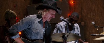 Movie still from “Black Snake Moan” (2006), directed by Craig Brewer – A man in a cowboy hat is playing a guitar; Close Up shot, Low angle