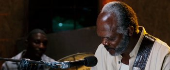 Movie still from “Black Snake Moan” (2006), directed by Craig Brewer – An older man with a microphone in front of him; Close Up shot, High angle