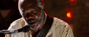 Movie still from “Black Snake Moan” (2006), directed by Craig Brewer – An older black man with a microphone in his mouth; Close Up shot, Low angle