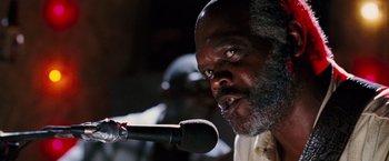 Movie still from “Black Snake Moan” (2006), directed by Craig Brewer – A man with a beard is speaking into a microphone; Close Up shot, Low angle