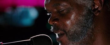 Movie still from “Black Snake Moan” (2006), directed by Craig Brewer – A person singing into a microphone; Extreme Close Up shot, Low angle