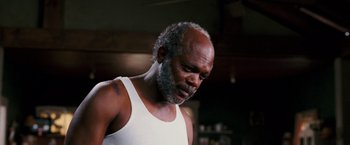 Movie still from “Black Snake Moan” (2006), directed by Craig Brewer – An older man in a white tank top looking down; Close Up shot, High angle