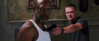 Movie still from “Black Snake Moan” (2006), directed by Craig Brewer – A man holding a gun pointed at a black man; Close Up shot, Over the shoulder angle
