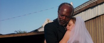 Movie still from “Black Snake Moan” (2006), directed by Craig Brewer – An older man and a young woman are hugging; Close Up shot, Low angle