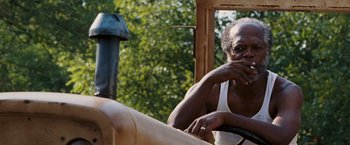 Movie still from “Black Snake Moan” (2006), directed by Craig Brewer – An older man sitting on top of a tractor; Close Up shot, Over the shoulder angle