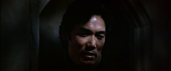 Movie still from “Black Sunday” (1977), directed by John Frankenheimer – A person wearing a black shirt; Close Up shot, Low angle