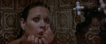 Movie still from “Black Sunday” (1977), directed by John Frankenheimer – A young woman is taking a bath in the shower; Close Up shot, Low angle