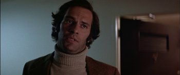 Movie still from “Black Sunday” (1977), directed by John Frankenheimer – A person wearing a sweater; Close Up shot, Low angle