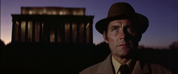 Movie still from “Black Sunday” (1977), directed by John Frankenheimer – A man wearing a hat and a suit and tie; Close Up shot, Low angle