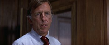 Movie still from “Black Sunday” (1977), directed by John Frankenheimer – A person wearing a shirt and a tie; Close Up shot, Low angle