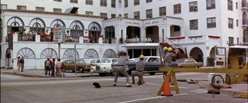 Movie still from “Black Sunday” (1977), directed by John Frankenheimer – A group of men riding skateboards down a street; Wide shot, Low angle