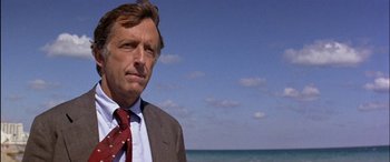 Movie still from “Black Sunday” (1977), directed by John Frankenheimer – A person wearing a suit and tie; Close Up shot, Low angle